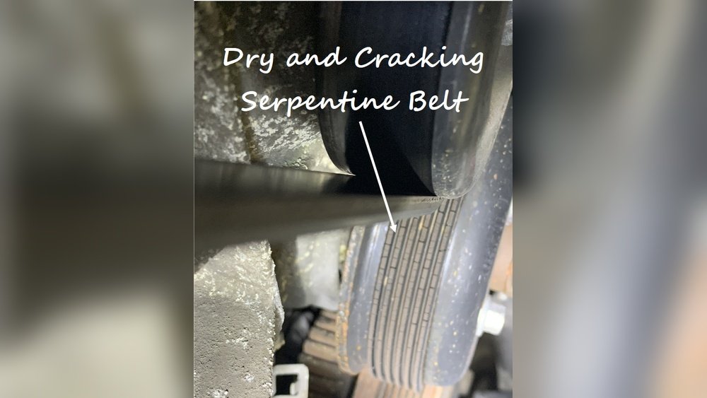 Dry and cracking serpentine belt showing signs of wear
